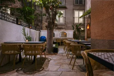 a row of tables and chairs in a restaurant at Hotel Amarano Burbank-Hollywood in Burbank