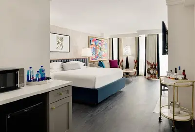 a bedroom with a bed and a living room at Le Parc at Melrose in Los Angeles