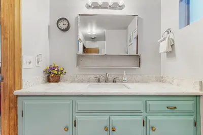 a bathroom with a sink and a mirror at The Treehouse in Lake Arrowhead