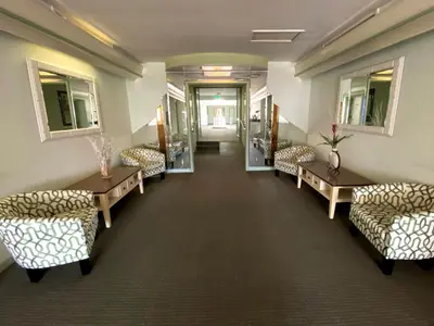 a waiting room with couches and tables and windows at Hollywood Celebrity Hotel in Los Angeles