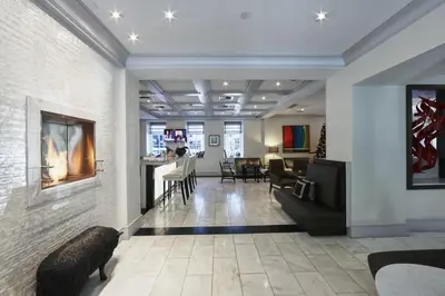 a lobby with a living room and a dining room at Mosaic Hotel Beverly Hills in Los Angeles