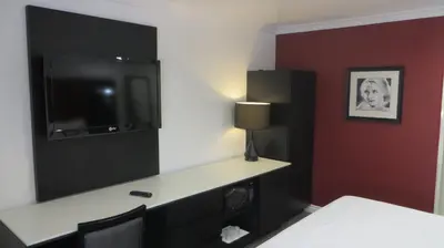 a hotel room with a desk and a tv in a room at Legend Hotel Hollywood in Los Angeles