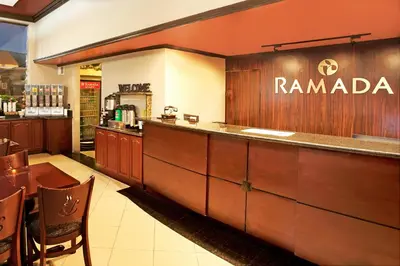 a restaurant with a counter and a bar at Ramada by Wyndham Pasadena in Pasadena