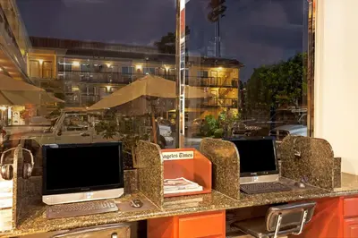 two laptops sitting on a counter in front of a window at Ramada by Wyndham Pasadena in Pasadena