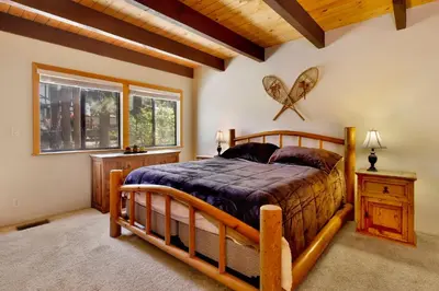 a bedroom with a wooden bed and a window at All Season Alpine Retreat-1184 by Big Bear Vacations in Big Bear Lake