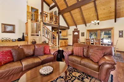 a living room with leather couches and a table at All Season Alpine Retreat-1184 by Big Bear Vacations in Big Bear Lake