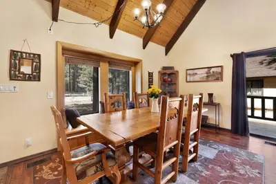 a dining room with a wooden table and chairs at All Season Alpine Retreat-1184 by Big Bear Vacations in Big Bear Lake
