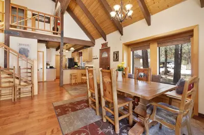 a kitchen and dining room with a wooden table and chairs at All Season Alpine Retreat-1184 by Big Bear Vacations in Big Bear Lake