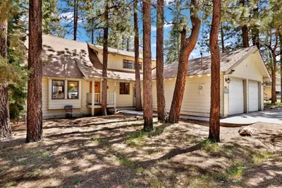 a house with trees in front of it at All Season Alpine Retreat-1184 by Big Bear Vacations in Big Bear Lake