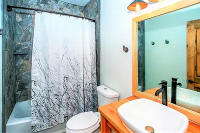 a bathroom with a toilet and a sink and a shower at Alpine Chalet-1840 by Big Bear Vacations in Big Bear Lake