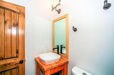 a bathroom with a sink and a mirror at Alpine Chalet-1840 by Big Bear Vacations in Big Bear Lake
