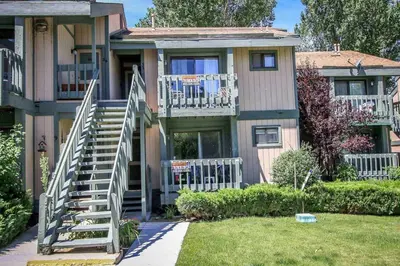 a house with stairs leading up to a balcony at Boulder Creek-1412 by Big Bear Vacations in Big Bear Lake
