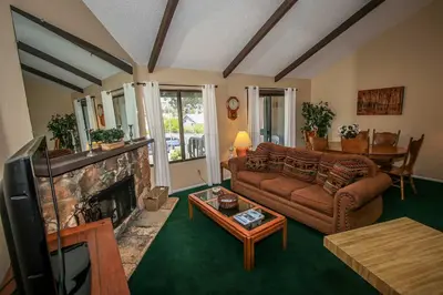 a living room with a couch and a fireplace at Boulder Creek-1412 by Big Bear Vacations in Big Bear Lake