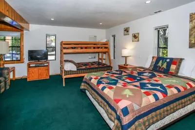 a bedroom with a bed and a television in it at Breezy Estate-114 by Big Bear Vacations in Big Bear Lake