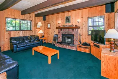 a living room with a couch and a fireplace at Breezy Estate-114 by Big Bear Vacations in Big Bear Lake