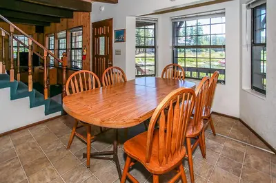 a dining room with a wooden table and chairs at Breezy Estate-114 by Big Bear Vacations in Big Bear Lake