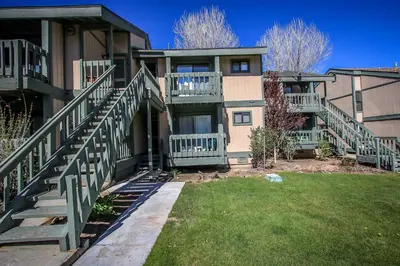a building with stairs and a lawn in front of it at Boulder Creek -1417 by Big Bear Vacations in Big Bear Lake
