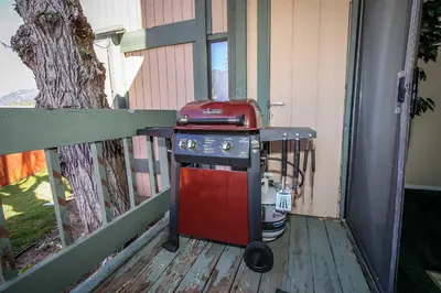 a grill sitting on the porch of a house at Boulder Creek -1417 by Big Bear Vacations in Big Bear Lake