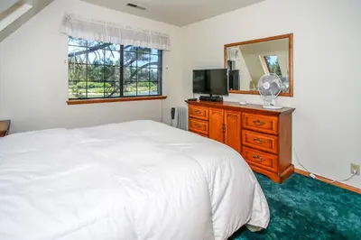a bedroom with a bed and a television and a mirror at Breezy One-112 by Big Bear Vacations in Big Bear Lake