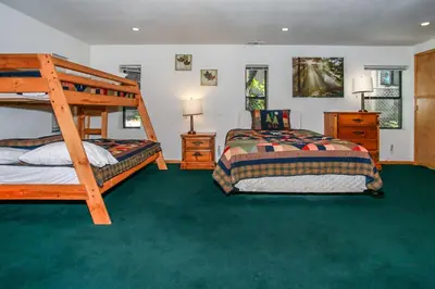 a bedroom with two beds and a bunk bed at Breezy One-112 by Big Bear Vacations in Big Bear Lake