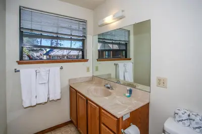a bathroom with a sink and a mirror at Breezy One-112 by Big Bear Vacations in Big Bear Lake