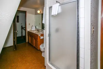a bathroom with a shower and a toilet and a sink at Breezy Two-113 by Big Bear Vacations in Big Bear Lake