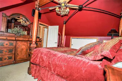 a bedroom with a bed and a wooden dresser at Knotty and Nice-177 by Big Bear Vacations in Big Bear Lake