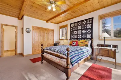 a bedroom with a bed and a wooden ceiling at Starlight Vistas-1524 by Big Bear Vacations in Big Bear Lake