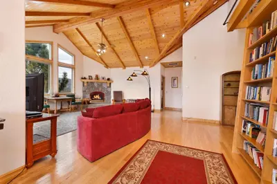 a living room with a red couch and a fireplace at Starlight Vistas-1524 by Big Bear Vacations in Big Bear Lake