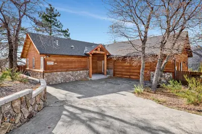 a log cabin with a driveway in front of it at Starlight Vistas-1524 by Big Bear Vacations in Big Bear Lake
