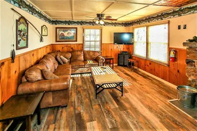 a living room with a leather couch and a table at Frank's Old Bear-149 by Big Bear Vacations in Big Bear Lake