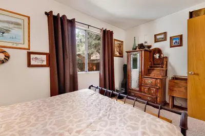 a bedroom with a bed and a dresser and a window at Popko's Place Resort Chalet by Big Bear Vacations in Big Bear Lake