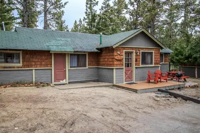 a small house with a porch and a patio at Shore Acres Lodge-451 by Big Bear Vacations in Big Bear Lake