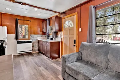 a living room with a couch and a kitchen at Shore Acres Lodge-451 by Big Bear Vacations in Big Bear Lake