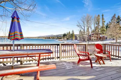 a table and two chairs and an umbrella on a deck at Shore Acres Lodge-450 by Big Bear Vacations in Big Bear Lake