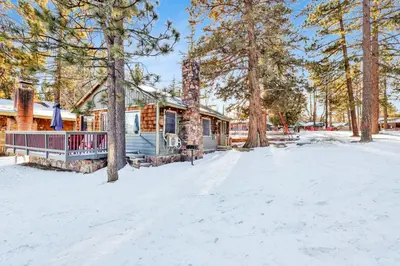 a cabin in the woods in the snow at Lakeside Family Cabin by Big Bear Vacations in Big Bear Lake