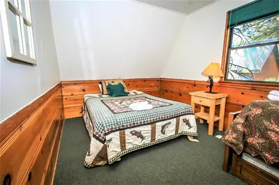 a bedroom with a bed and a window at Kelley's Kabin-290 by Big Bear Vacations in Big Bear Lake