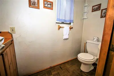a bathroom with a white toilet and a window at Kelley's Kabin-290 by Big Bear Vacations in Big Bear Lake