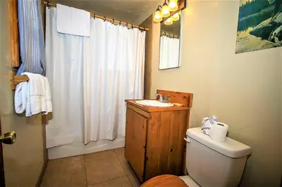 a bathroom with a sink and a toilet and a shower at Kelley's Kabin-290 by Big Bear Vacations in Big Bear Lake