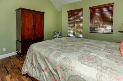 a bedroom with a bed and a dresser and window at Fawnskin Chalet-1826 by Big Bear Vacations in Fawnskin