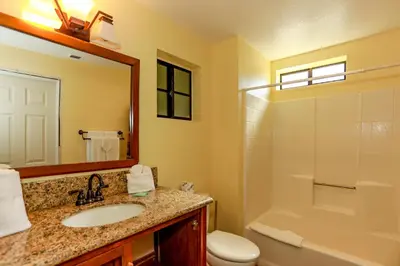a bathroom with a sink and a toilet and a shower at Fawnskin Chalet-1826 by Big Bear Vacations in Fawnskin
