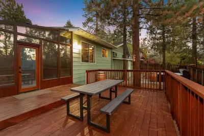 a wooden deck with a bench and a house at Mountain Fun-1729 by Big Bear Vacations in Big Bear Lake