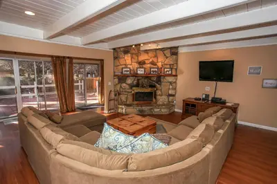 a living room with a large couch and a fireplace at Cozy up to Summit-1651 by Big Bear Vacations in Big Bear Lake