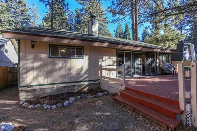a small house with a porch and a deck at Cozy up to Summit-1651 by Big Bear Vacations in Big Bear Lake