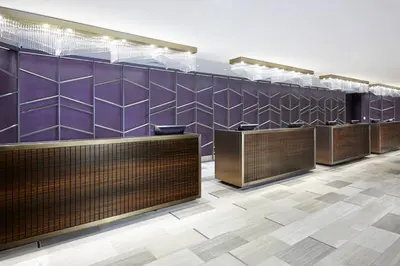 a row of counters in a room with purple tiles at Sheraton Gateway Los Angeles Hotel in Los Angeles