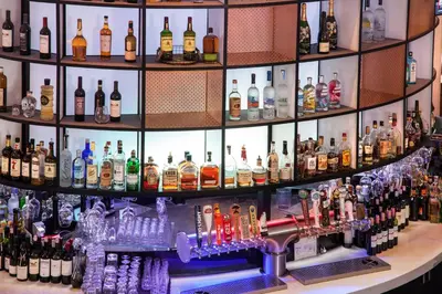a bar filled with lots of bottles of alcohol at Sheraton Gateway Los Angeles Hotel in Los Angeles