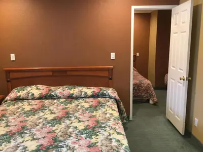 a bedroom with a bed with a floral bedspread at Beverly Inn in Los Angeles