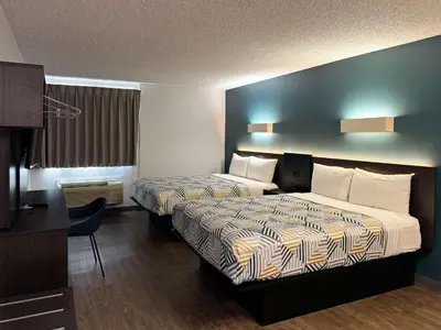 a hotel room with two beds and a desk at Motel 6-Carson, CA in Carson