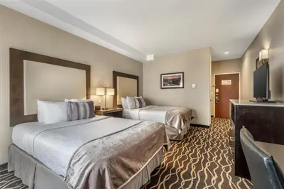 a hotel room with two beds and a flat screen tv at Best Western Plus Hotel at the Convention Center in Long Beach