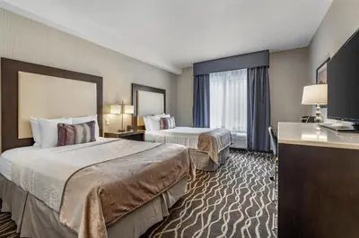 a hotel room with two beds and a large window at Best Western Plus Hotel at the Convention Center in Long Beach